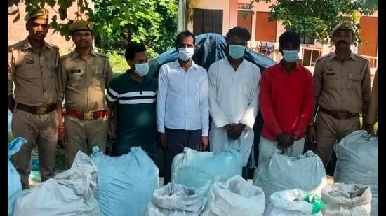 A police team with seized crackers and accused held during a raid at a house in Nagaram on the outskirts of Lucknow recently (Sourced)