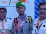 Dr. Kartik Karkera (C), an orthopaedic surgeon from Nashik, with his father and coach after coming third in the race for Elite Indian Men in the New Delhi Half Marathon on Sunday. (HT Photo)