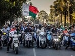 Motorcyclists drive chanting anti-government slogans and waving Malagasy flags as they celebrate in downtown Antananarivo, Motorcyclists drive chanting anti-government slogans and waving Malagasy flags as they celebrate in downtown Antananarivo,
