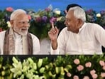 Prime Minister Narendra Modi speaks with Nitish Kumar, chief minister of Bihar, during a public meeting in Gaya on August 22, 2025. Prime Minister Narendra Modi speaks with Nitish Kumar, chief minister of Bihar, during a public meeting in Gaya on August 22, 2025.