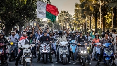 Motorcyclists drive chanting anti-government slogans and waving Malagasy flags as they celebrate in downtown Antananarivo, (AFP) Motorcyclists drive chanting anti-government slogans and waving Malagasy flags as they celebrate in downtown Antananarivo, (AFP)