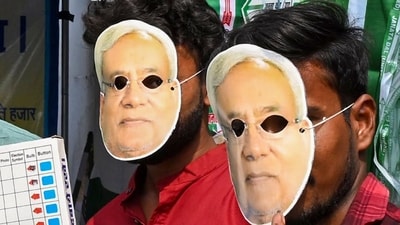 JDU supporters wear masks of CM Nitish Kumar and hold EVM replicas as they gear up for the Bihar assembly election 2025 campaign in Patna on Sunday, October 12. (PTI)