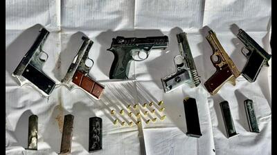 The seized arms include one PX5 pistol, one .30 bore pistol, and four .32 bore pistols, along with 19 live cartridges (HT Photo) The seized arms include one PX5 pistol, one .30 bore pistol, and four .32 bore pistols, along with 19 live cartridges (HT Photo)