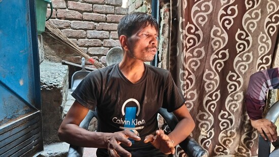 Rakesh speaks during an interview, at Seemapuri, in New Delhi as he explains about his hazardous work conditions and his dependence on debt for treatment.(PTI)