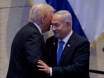 U.S. President Donald Trump and Israeli Prime Minister Benjamin Netanyahu interact after Netanyahu addressed the Knesset on October 13, 2025 in Jerusalem.  