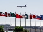 A plane flies, as flags flutter, ahead of an international summit on Gaza, held amid a ceasefire between Israel and Hamas, at Egypt's Red Sea resort of Sharm el-Sheikh, Egypt, October 12, 2025. REUTERS/Amr Abdallah Dalsh
