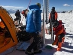 This picture shows expedition chief Evan Miles (right) and Russia's paleoclimatologist and glaciologist Stanislav Kutuzov, (left) taking a “carrot” of ice out of the Pamir glacier as part of the expedition in Kon Chukurbashi, Eastern Tajikistan, on September 24 . (AFP)