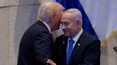 U.S. President Donald Trump and Israeli Prime Minister Benjamin Netanyahu interact after Netanyahu addressed the Knesset on October 13, 2025 in Jerusalem. (via REUTERS)