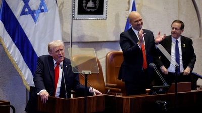 Trump addresses the Knesset, Israel’s parliament, next to Amir Ohana, Speaker of the Israeli Knesset, and Israeli President Isaac Herzog on October 13, 2025 in Jerusalem. Members of the Knesset plenum gave Trump a standing ovation that lasted&nbsp;for two and a half minutes. Chip Somodevilla/Pool via REUTERS (via REUTERS)