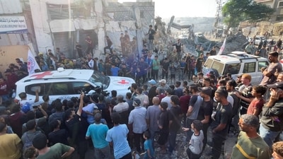 Crowd flocks around the red cross vehicle that transport Israeli hostages released by Gaza. (Dawoud Abu Alkas/REUTERS)