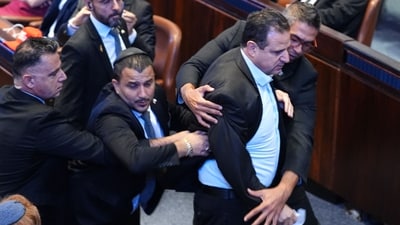 Israeli Knesset member Ayman Odeh (2R) is escorted out after holding a sign reading "Recognise Palestine" during a speech by US President Donald Trump at the Israeli parliament, the Knesset, in Jerusalem on October 13, 2025.(Photo by Evan Vucci / POOL / AFP) (AFP) Israeli Knesset member Ayman Odeh (2R) is escorted out after holding a sign reading "Recognise Palestine" during a speech by US President Donald Trump at the Israeli parliament, the Knesset, in Jerusalem on October 13, 2025.(Photo by Evan Vucci / POOL / AFP) (AFP)