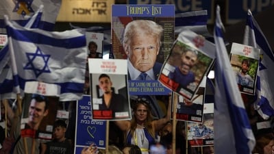 People holding up portraits of Israeli hostages held in Gaza and waving Israeli national flags, along with a poster depicting US President Donald Trump, gather at Hostage Square in Tel Aviv. (Ahmed Gharabli/AFP) People holding up portraits of Israeli hostages held in Gaza and waving Israeli national flags, along with a poster depicting US President Donald Trump, gather at Hostage Square in Tel Aviv. (Ahmed Gharabli/AFP)