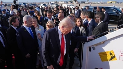 President Donald Trump boards Air Force One at Ben Gurion International Airport, Monday, Oct. 13, 2025, near Tel Aviv. As Israel's President Isaac Herzog and Israel's Prime Minister Benjamin Netanyahu watch. (AP Photo/Evan Vucci) (AP) President Donald Trump boards Air Force One at Ben Gurion International Airport, Monday, Oct. 13, 2025, near Tel Aviv. As Israel's President Isaac Herzog and Israel's Prime Minister Benjamin Netanyahu watch. (AP Photo/Evan Vucci) (AP)