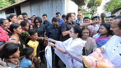 West Bengal chief minister Mamata Banerjee distributing relief materials for flood and landslide victims in Alipurduar on Sunday. (ANI)