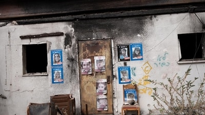 The home of hostage David Cunio in Nir Oz. Posters show him and family members. The home of hostage David Cunio in Nir Oz. Posters show him and family members.