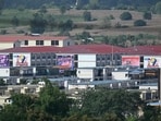 This photo taken on September 17, 2025 shows advertisements for gambling sites and what appears to be Starlink satellite dishes on the roofs of buildings at KK Park complex in Myanmar's eastern Myawaddy township.