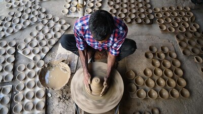 Gram it: Potters across Delhi-NCR are working day and night to make diyas (earthen lamps) ahead of Diwali (October 2). Here's a potter, near Sheetla Mata Mandir, in Gurugram, ( Photo: Parveen Kumar/HT)