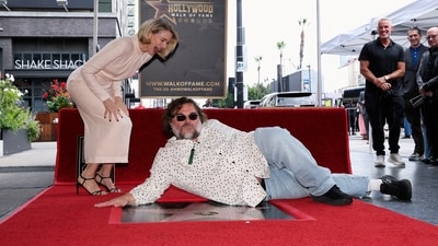 Actor Naomi Watts reacts as actor Jack Black poses on her newly unveiled star. (REUTERS)