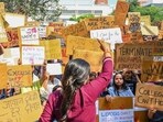 Students hold aloft placards during their protest at the SAU campus on Wednesday. (Vipin Kumar/HT Photo)