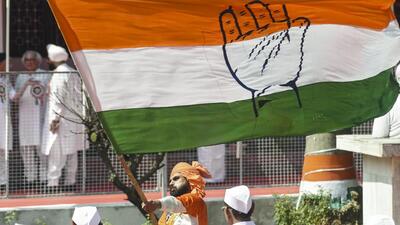 A Congress supporter waves the party flag in Patna, Bihar. (PTI) A Congress supporter waves the party flag in Patna, Bihar. (PTI)
