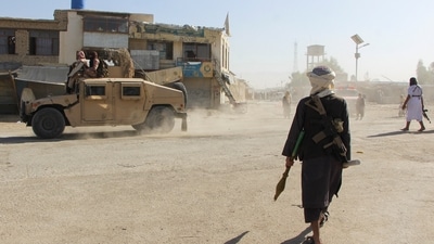 Afghan Taliban fighters patrol near the Afghanistan-Pakistan border in Spin Boldak, Kandahar Province on Wednesday (Reuters)