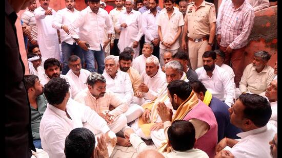 Haryana chief minister Nayab Singh Saini meeting family members of late ASI Sandeep Lathar at Ladhot village in Rohtak district on Wednesday. (Manoj Dhaka/HT)