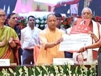 Chief minister Yogi Adityanath at an event in Lucknow where gas cylinder refill subsidies under the Pradhan Mantri Ujjwala Yojana were distributed on Wednesday. (HT)