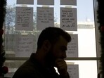 In this Monday, Dec. 23, 2019 photo, words of encouragement are taped to a window next to Bassem, a volunteer, as he waits for calls at at Lebanon's Embrace, a mental health organization operating the national suicide prevention helpline in Beirut. Lebanon is entering its third month of protests, the economic pinch is hurting everyone, and the government is paralyzed. So people are resorting to what they've done in previous crises: They rely on each other, not the state. (AP Photo/Maya Alleruzzo) (AP) In this Monday, Dec. 23, 2019 photo, words of encouragement are taped to a window next to Bassem, a volunteer, as he waits for calls at at Lebanon's Embrace, a mental health organization operating the national suicide prevention helpline in Beirut. Lebanon is entering its third month of protests, the economic pinch is hurting everyone, and the government is paralyzed. So people are resorting to what they've done in previous crises: They rely on each other, not the state. (AP Photo/Maya Alleruzzo) (AP)