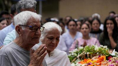 Father of Sumeet Sabharwal, a pilot who died in the AI crash offers prayers at his son’s funeral. (Reuters file photo) Father of Sumeet Sabharwal, a pilot who died in the AI crash offers prayers at his son’s funeral. (Reuters file photo)