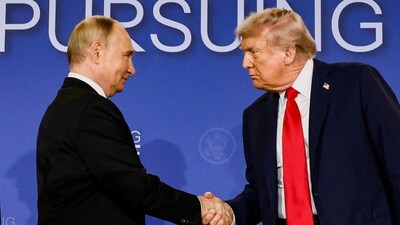 Donald Trump and Vladimir Putin shake hands during a press conference (REUTERS/File)