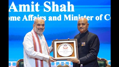 Union Home Minister Amit Shah, left, being felicitated by CBI director Praveen Sood (PIB) Union Home Minister Amit Shah, left, being felicitated by CBI director Praveen Sood (PIB)