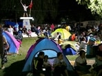 Residents gather at a park amidst a tsunami warning after a 6.7 aftershock hits Davao Oriental province, in Mindanao early evening on October 10, 2025.