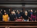 Lawyers of Ukrainian soldiers of the Aidar battalion captured by Russia during fighting in Ukraine stand in front of the defendants' cage during a hearing at the Southern District Military Court in Rostov-on-Don. (AP Photo)