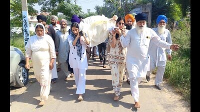 As the two young women lifted their father’s bier from the house, the entire village was overcome with emotion. (HT Photo) As the two young women lifted their father’s bier from the house, the entire village was overcome with emotion. (HT Photo)