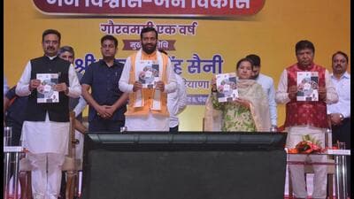 Haryana chief minister Nayab Singh Saini releasing a coffee table book during the state-level function that was held to mark the completion of one year of the BJP government in the state on Friday. (Sant Arora/Hindustan Times) Haryana chief minister Nayab Singh Saini releasing a coffee table book during the state-level function that was held to mark the completion of one year of the BJP government in the state on Friday. (Sant Arora/Hindustan Times)