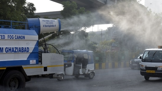 In view of rising pollution levels across Delhi-NCR, the Ghaziabad Municipal Corporation deployed an anti-smog water cannon to spray water on roads in the Indirapuram area to curb dust and improve air quality.(Sakib Ali / Hindustan Times)