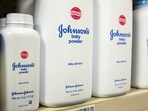 Bottles of Johnson & Johnson baby powder line a drugstore shelf in New York October 15, 2015. 