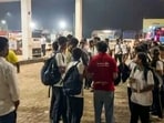 Stranded students wait at a petrol pump amid a traffic jam on the Mumbai-Ahmedabad National Highway at Vasai, in Palghar district, Maharashtra. 