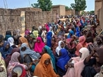 Sudanese residents gather to receive meals in Al Fasher. Sudanese residents gather to receive meals in Al Fasher.