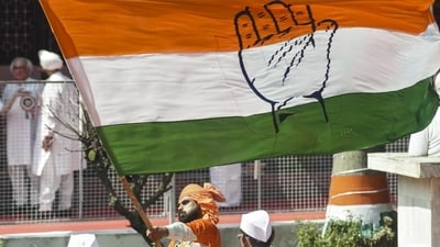 A Congress supporter waves the party flag in Patna, Bihar. (PTI) A Congress supporter waves the party flag in Patna, Bihar. (PTI)