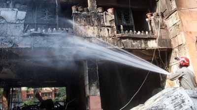 Firefighters attempt to douse a fire that broke out at the Brahmaputra Apartments in New Delhi on Saturday. (ANI)