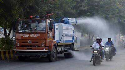A Ghaziabad Municipal Corporation truck uses a water cannon to sprinkle water on roads in the Indirapuram area to curb and pollution in Delhi-NCR on Friday. ( Sakib Ali/Hindustan Times)