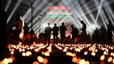 Earthen lamps, are lit along the Kartavya Path as laser show lights up the sky during ‘Delhi Deepotsav’ event, at the India Gate, in New Delhi, Saturday, Oct. 18, 2025. (PTI Photo/Salman Ali)&nbsp; (PTI)