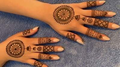 Families gather to perform Lakshmi Puja, thanking the goddess for health, happiness, and wealth. A circular floral motif radiates from the centre of the hand with stylish tassel details in this simple mehndi design, embodying harmony and positivity. (Pinterest) Families gather to perform Lakshmi Puja, thanking the goddess for health, happiness, and wealth. A circular floral motif radiates from the centre of the hand with stylish tassel details in this simple mehndi design, embodying harmony and positivity. (Pinterest)