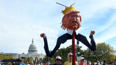 Demonstrators hold an effigy depicting U.S. President Donald Trump during a "No Kings" protest (REUTERS)