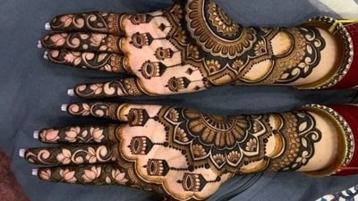 The festival honours Goddess Lakshmi, inviting wealth and abundance into our lives. This mehndi design features beautiful hanging jhumkas, an intricate mandala pattern, and delicate lotus motifs. (Pinterest) The festival honours Goddess Lakshmi, inviting wealth and abundance into our lives. This mehndi design features beautiful hanging jhumkas, an intricate mandala pattern, and delicate lotus motifs. (Pinterest)