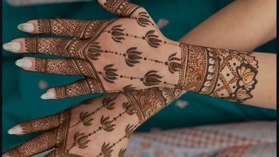 This mehndi design adorns the palms with lotus patterns, with intricate latticework on the fingers, symbolising the purity and spiritual intelligence of Goddess Lakshmi. (Pinterest) This mehndi design adorns the palms with lotus patterns, with intricate latticework on the fingers, symbolising the purity and spiritual intelligence of Goddess Lakshmi. (Pinterest)