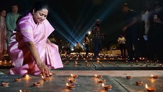 Delhi Chief Minister Rekha Gupta lights an earthen lamp during the Deep Mahotsav celebrations, at Kartavya Path in New Delhi on Saturday. (ANI Photo/Atul Kumar Yadav)(Atul Kumar Yadav)