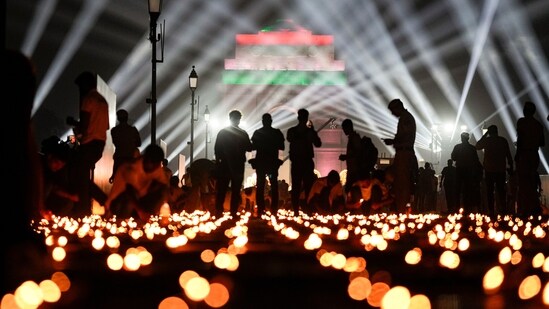 Earthen lamps, are lit along the Kartavya Path as laser show lights up the sky during ‘Delhi Deepotsav’ event, at the India Gate, in New Delhi, Saturday, Oct. 18, 2025. (PTI Photo/Salman Ali)&nbsp;(PTI)