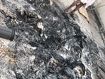Charred remnants of the electoral rolls recovered at the former legislator’s residence in Aland. (HT PHOTO)